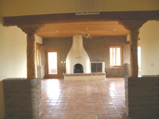 The great room with it's kiva fireplace from the entry.