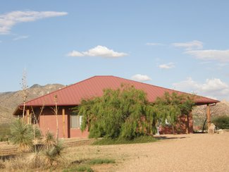 The front of the home which is surrounded by porches. The home has a detached garage.