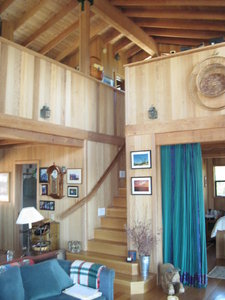 Living room with stairs to loft.  Loft has two sleeping areas, 1/2 bath, and office.