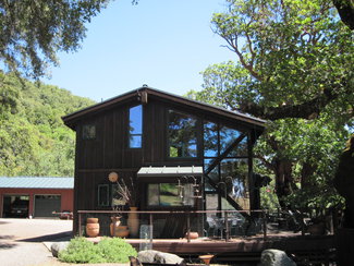 west end of house with garage beyond.